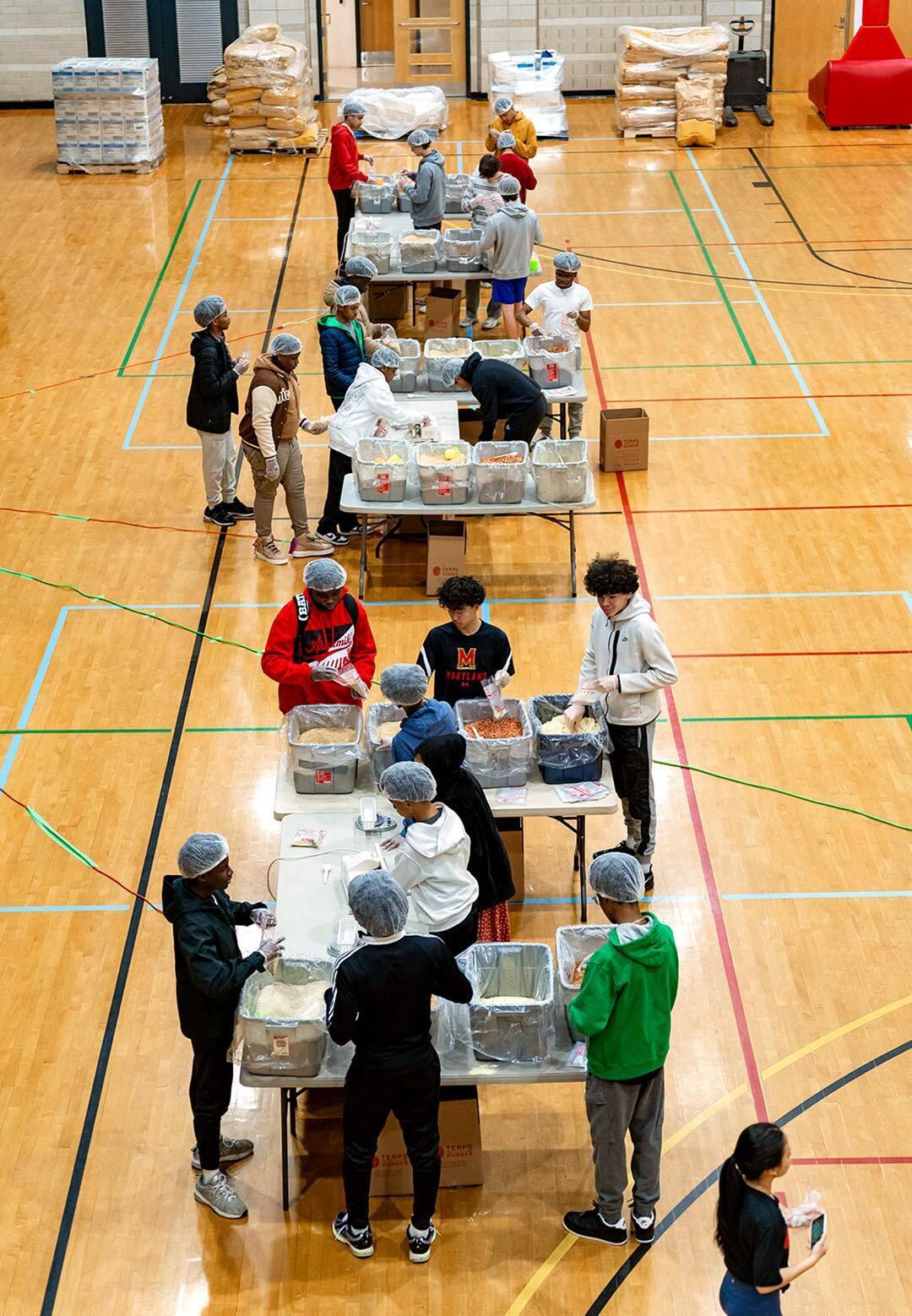 Maryland day guests fill bags of food at several tables