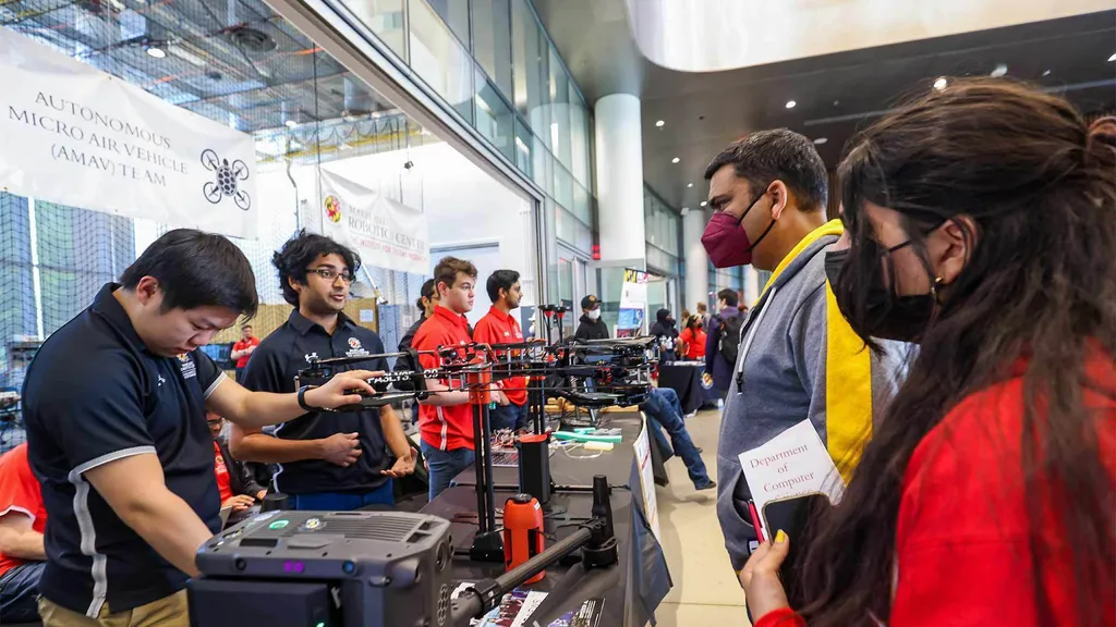 Visitors look at drones