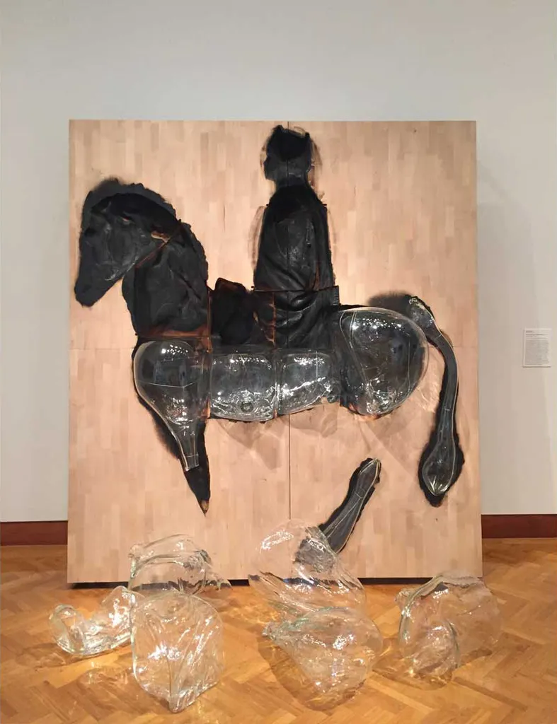 sculpture of man riding horse