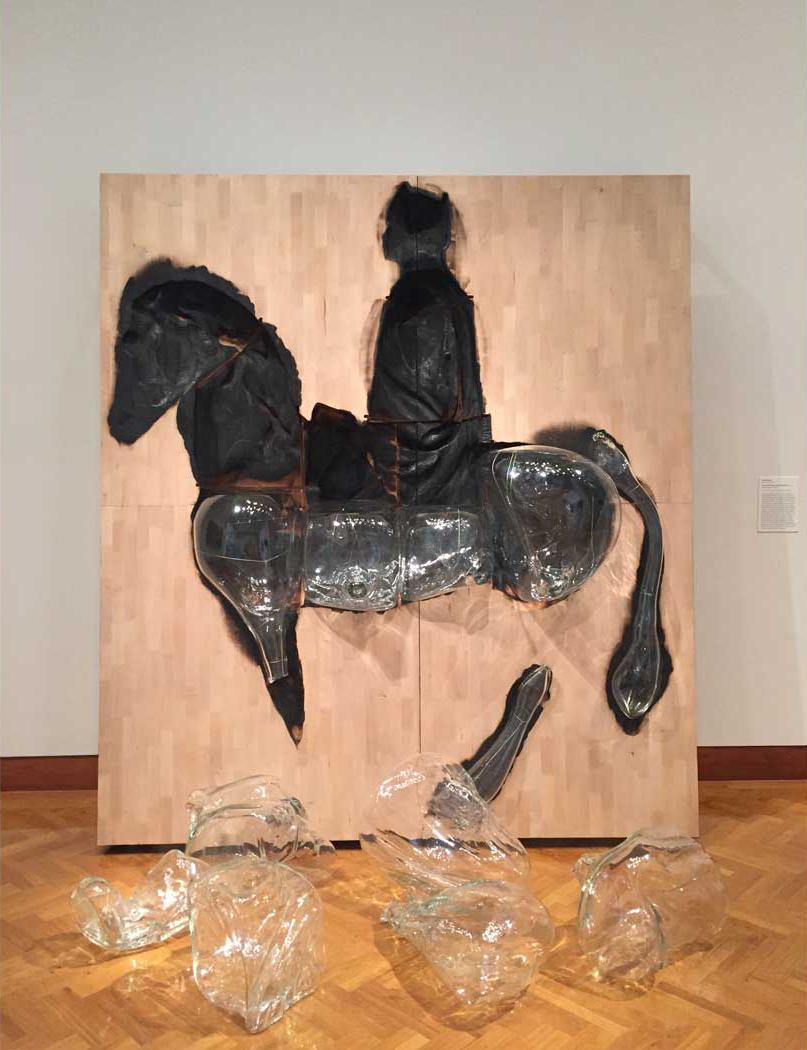sculpture of man riding horse