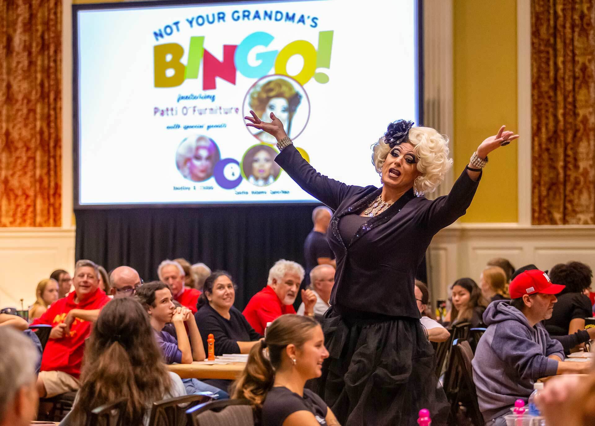 drag performer oversees big game of bingo with many families