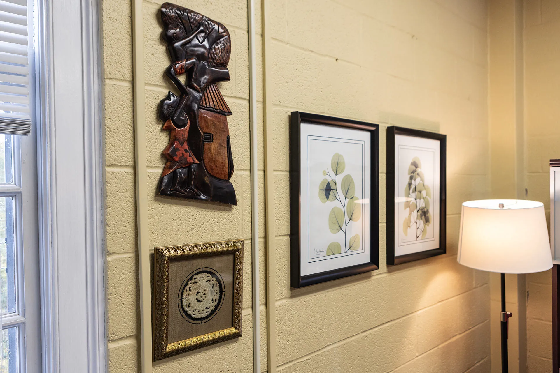 African art, including wood carving of a child lifting another up to a tree