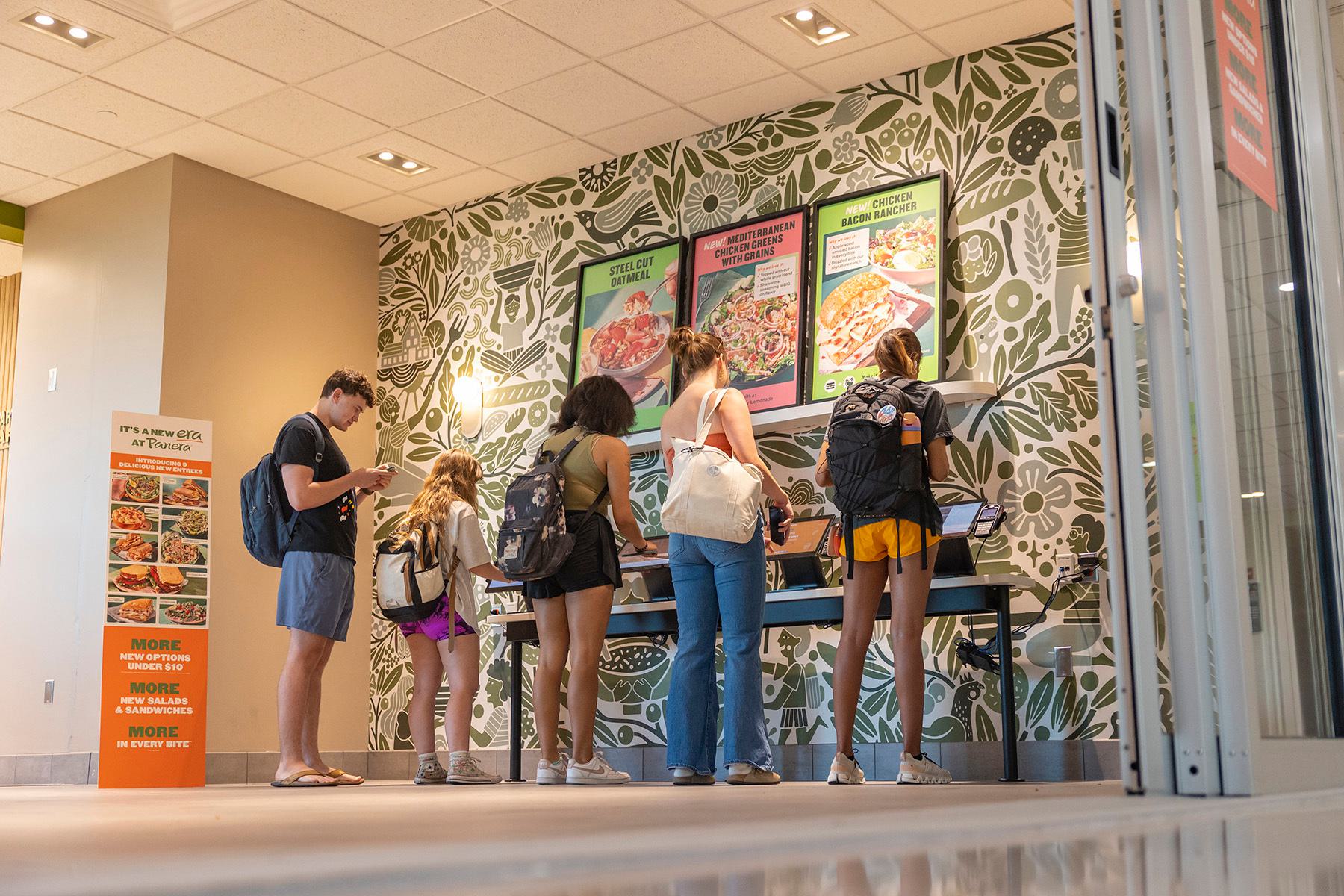 students order at kiosks at Panera