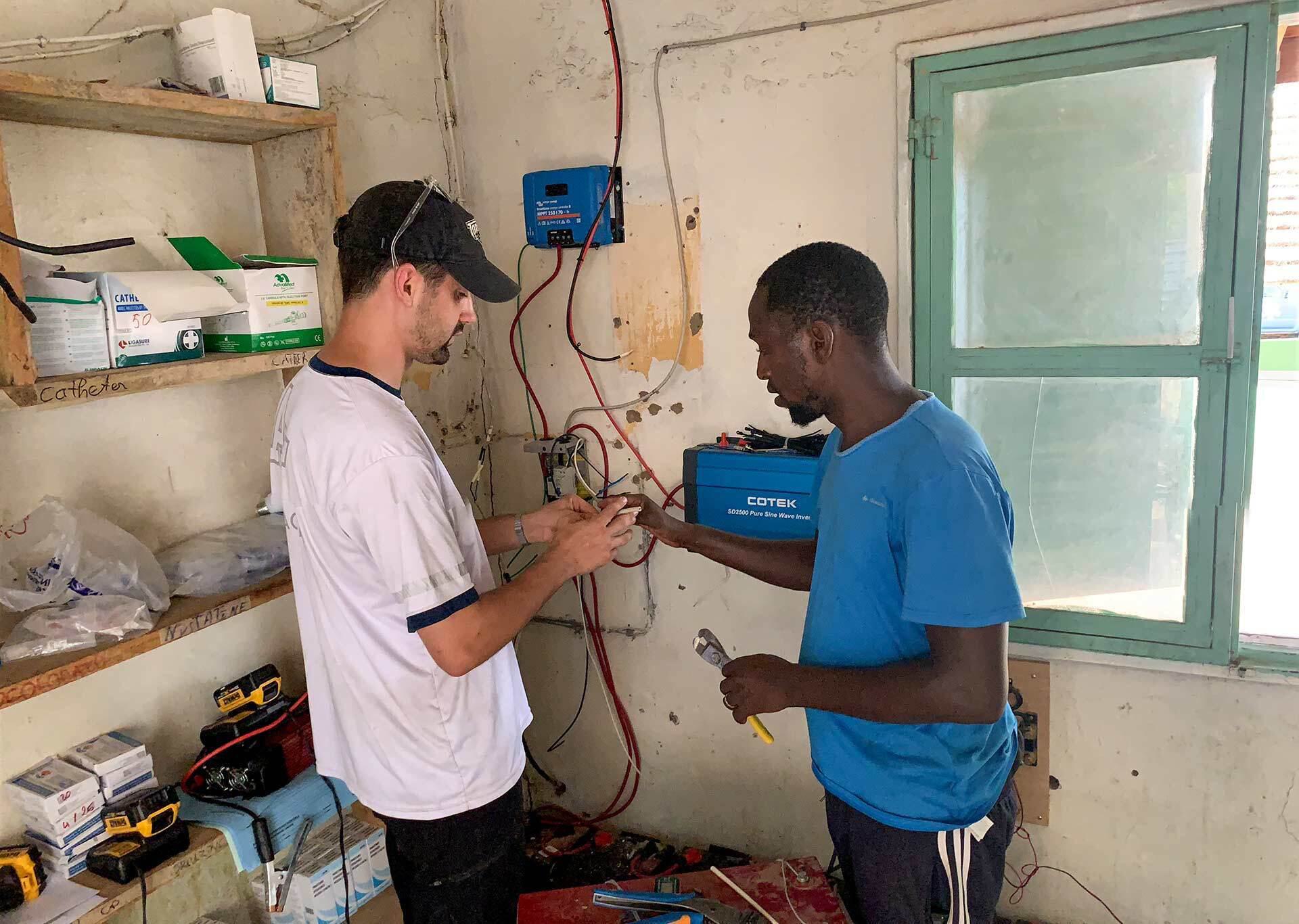 two people work with wires