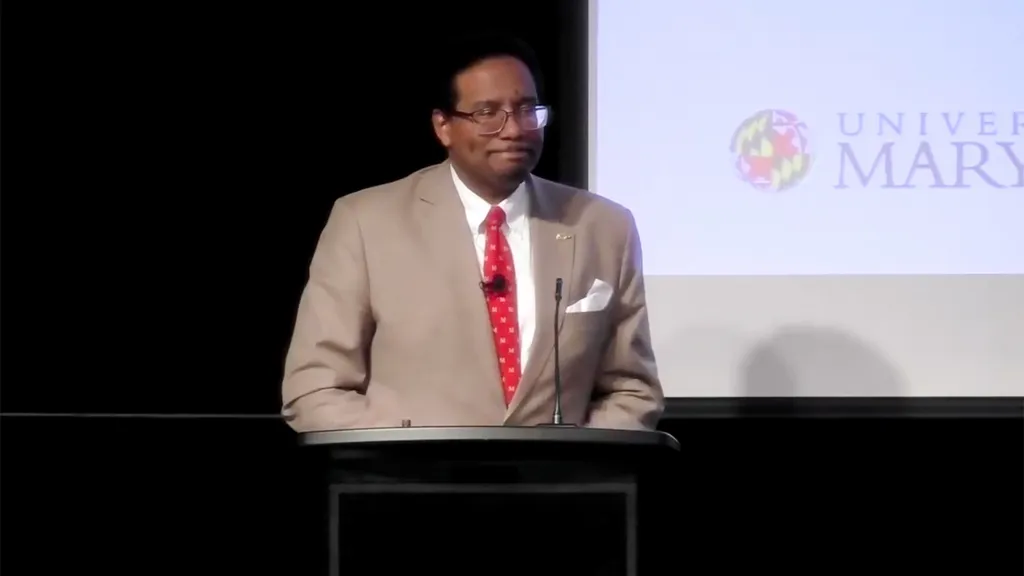 President Pines speaks at podium