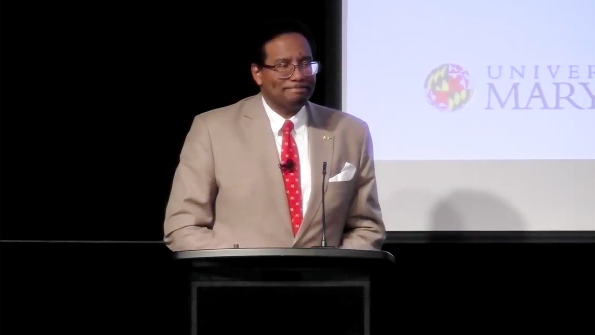 President Pines speaks at podium