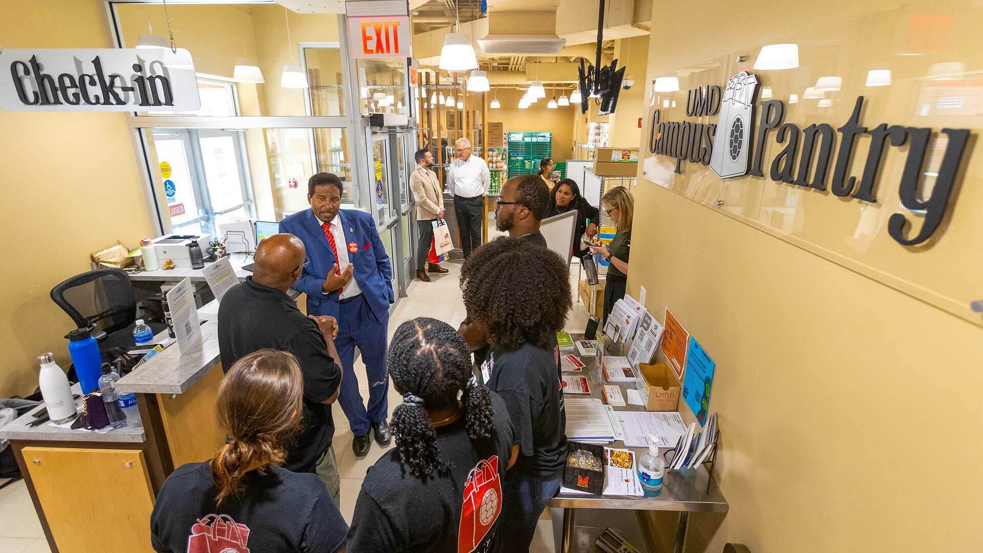 Pines talks to staff at Campus Pantry