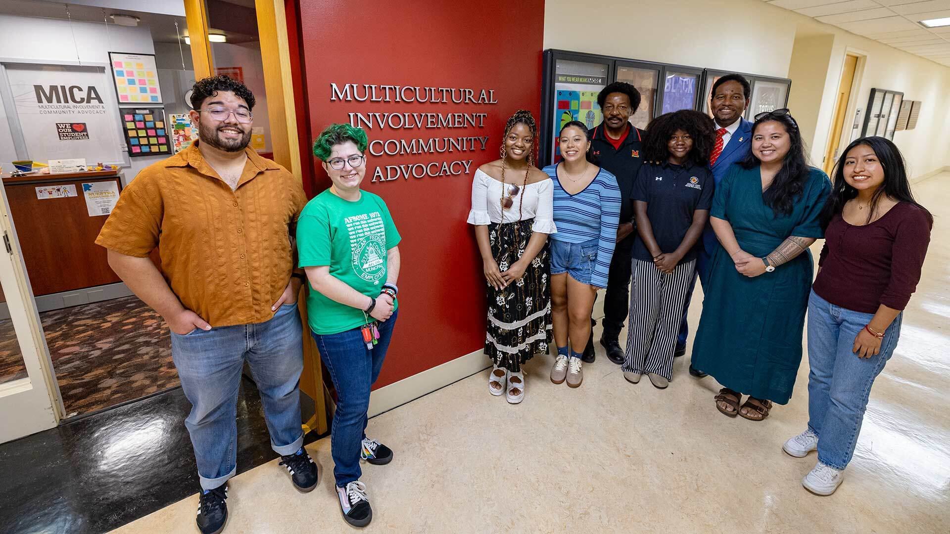 group poses outside MICA office