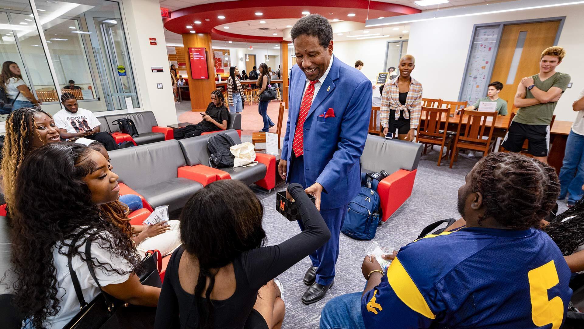 Pines hands out turtle pins to student group