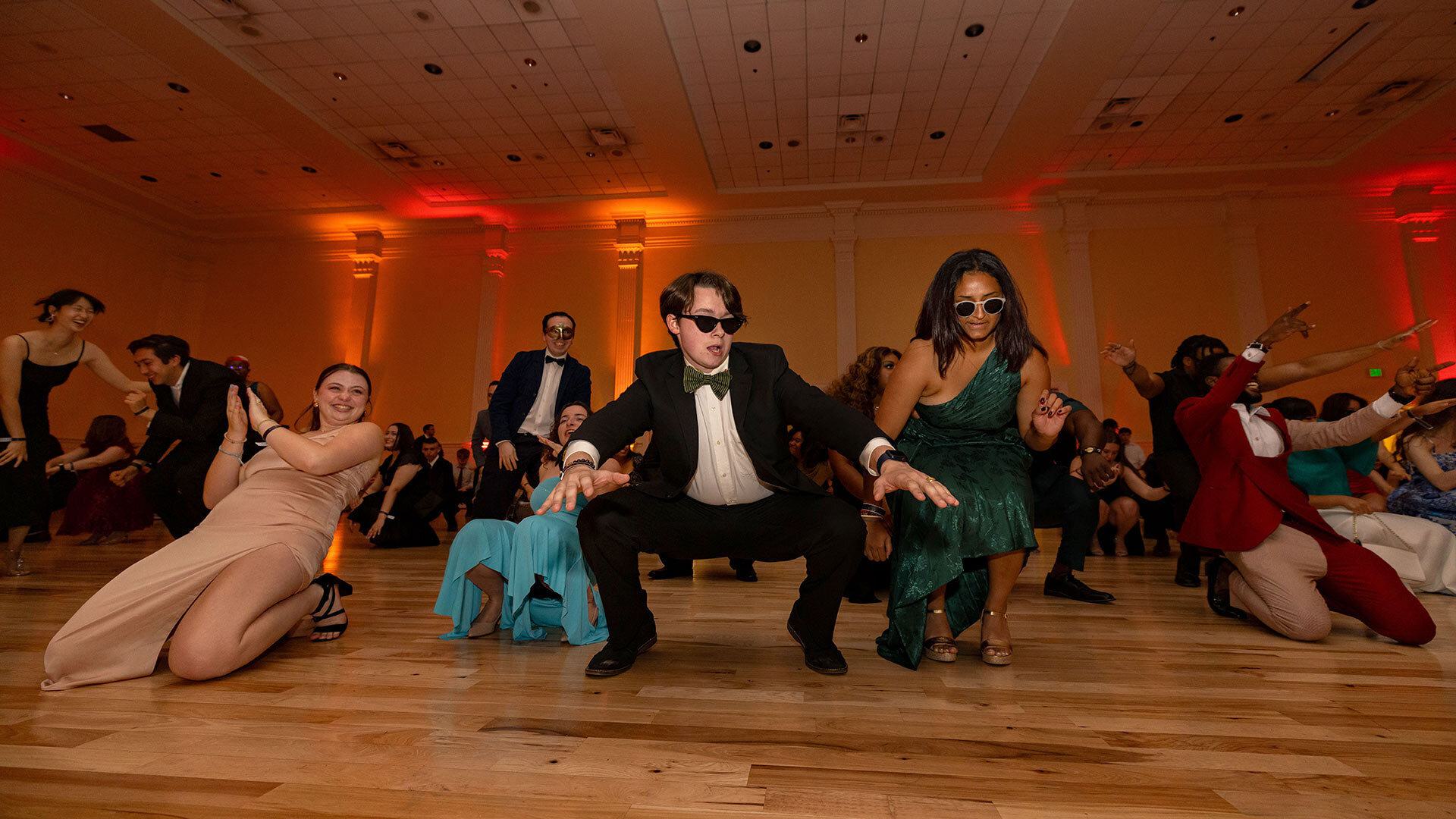 a line of dancers crouches