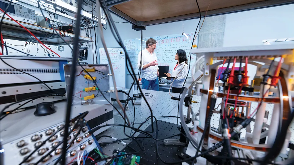 two researchers talk in lab