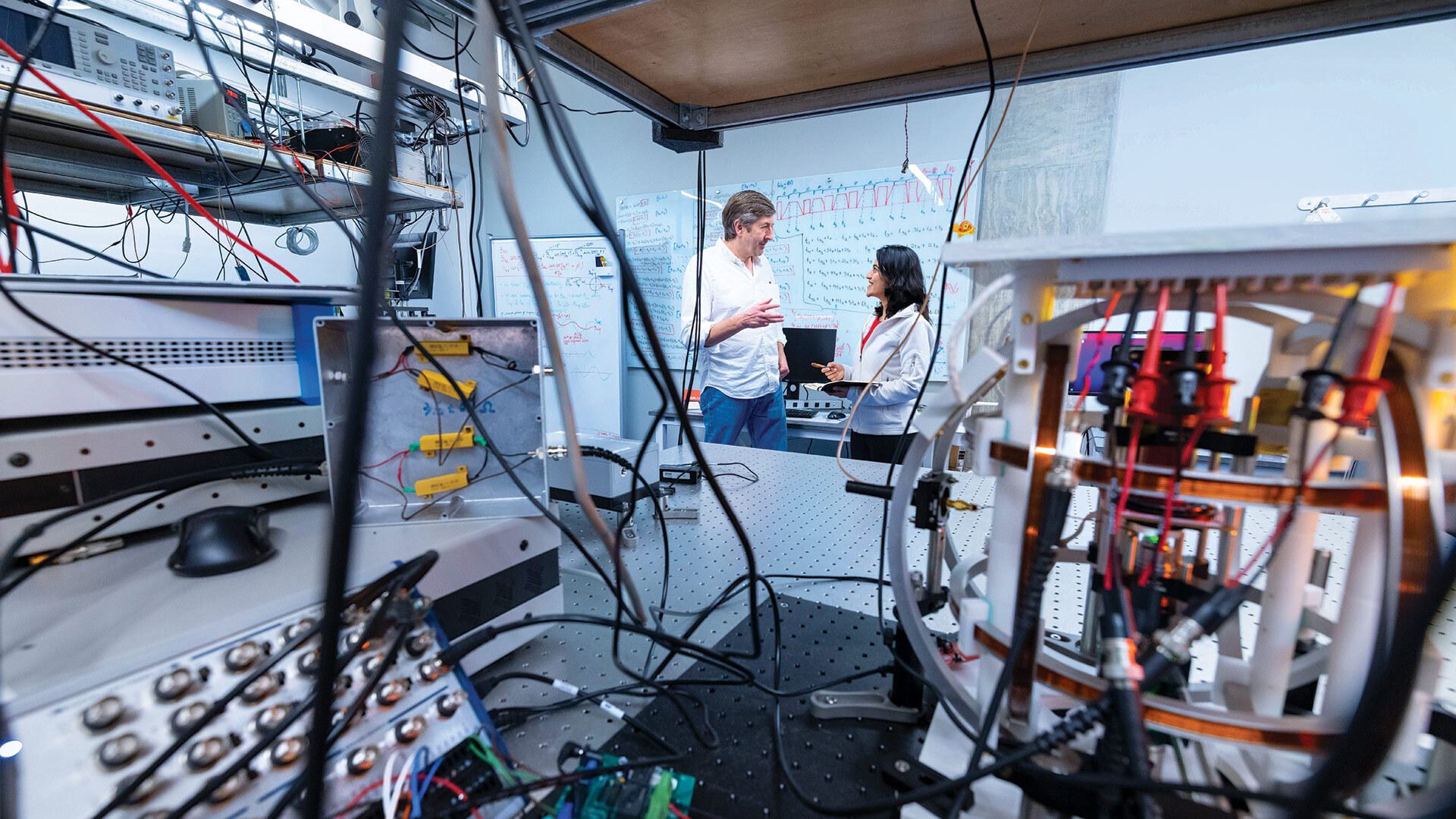 two researchers talk in lab