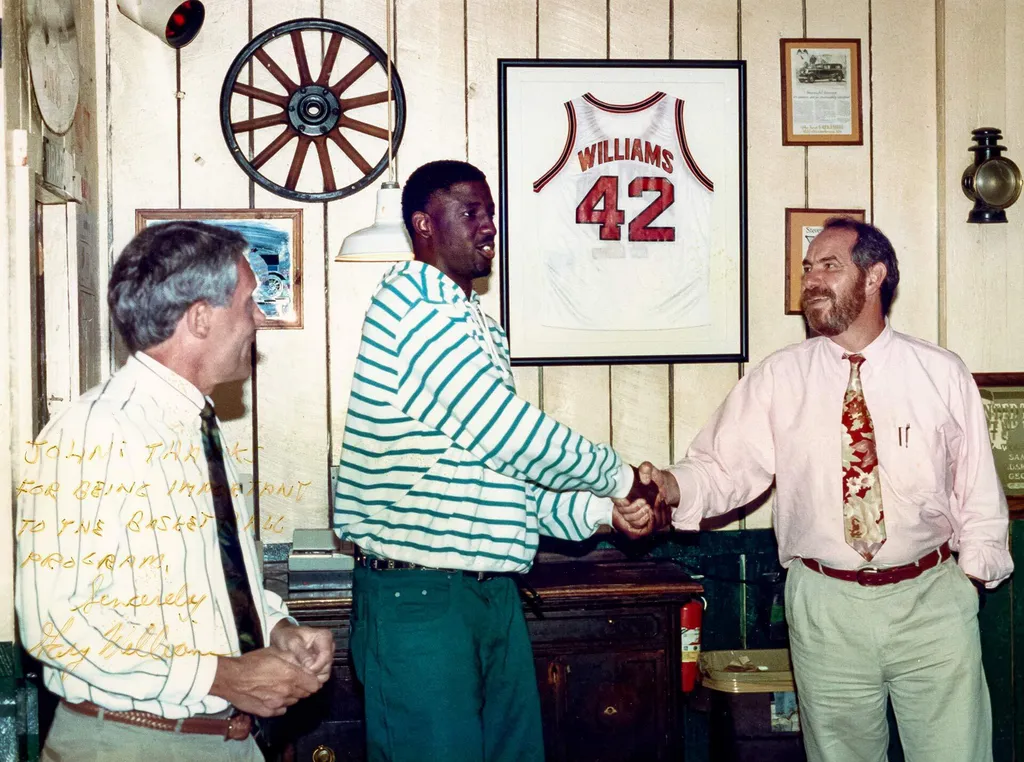 signed image of coach, player and restaurateer in office