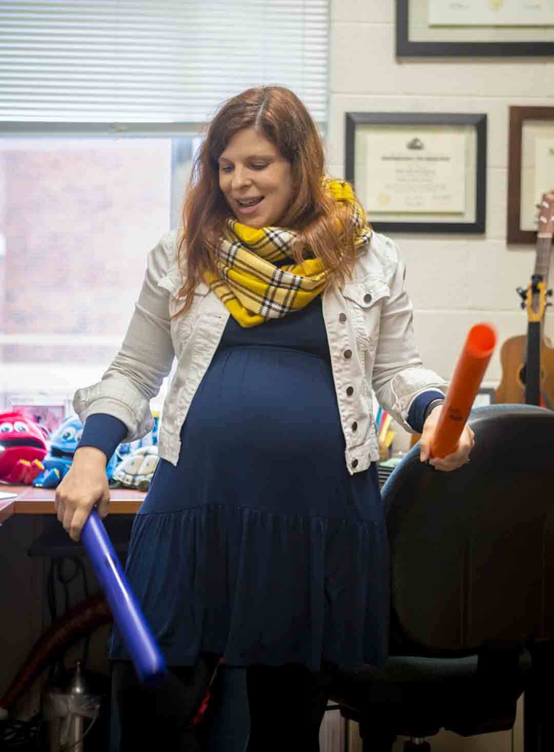 Robin Giebelhausen holds blue and orange boomwhackers