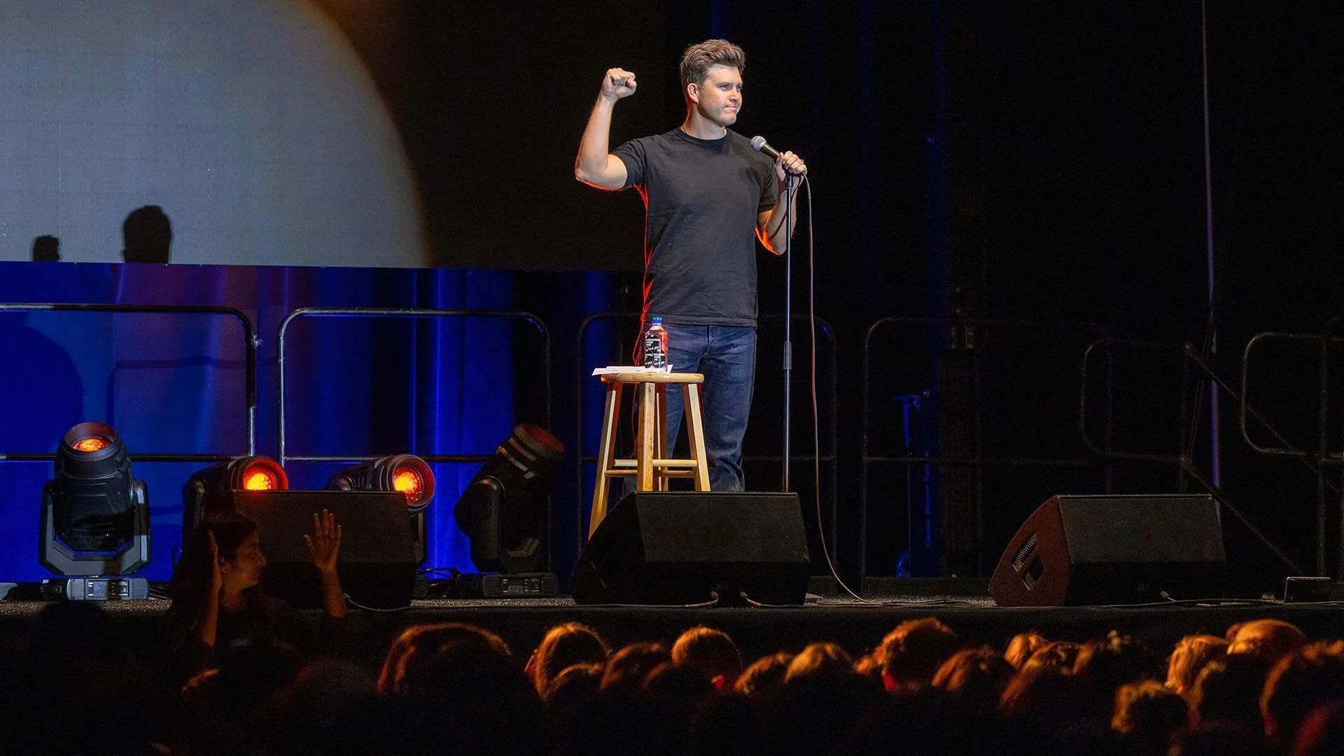colin jost on stage at comedy show
