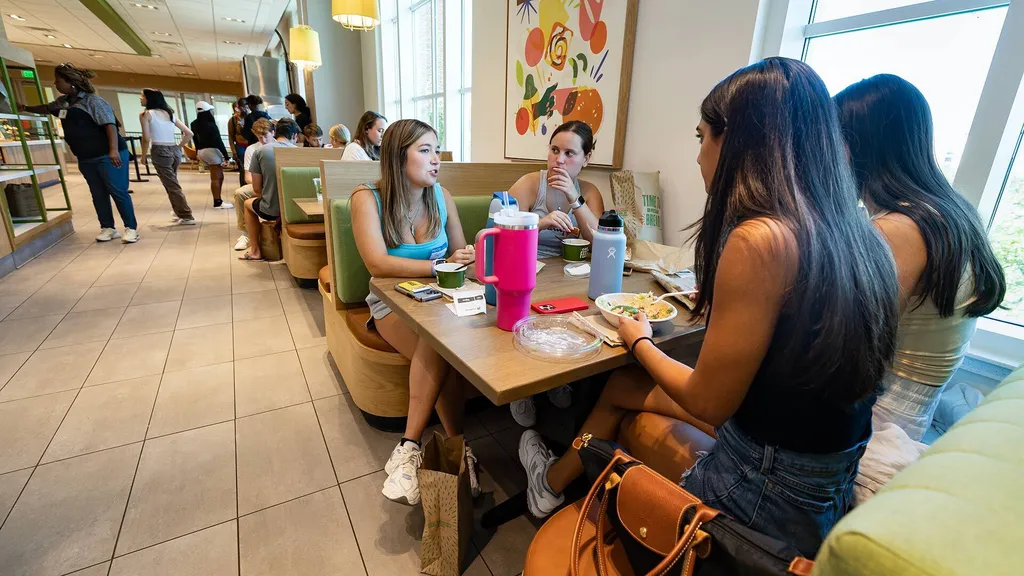 students eat at booth in Panera