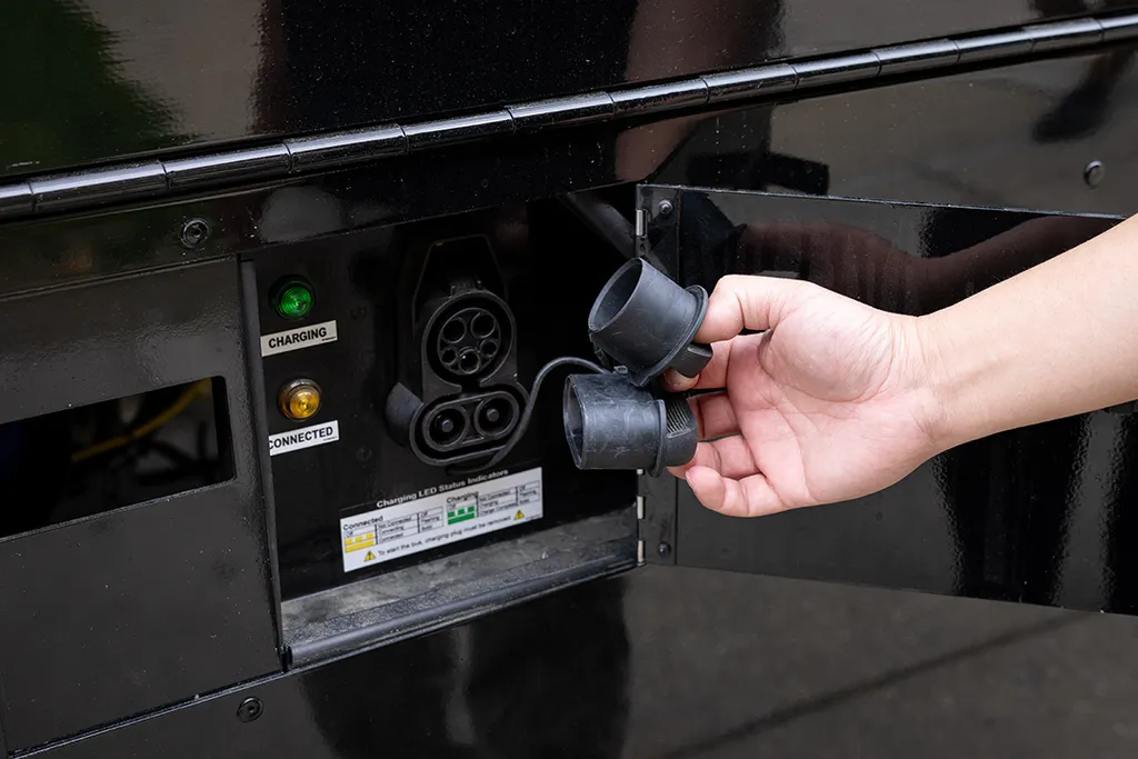 hand shows charging port in Shuttle-UM bus