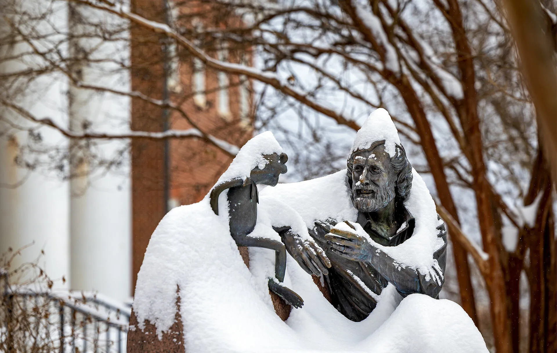 Snow covers the Jim Henson statue at Stamp Student Union