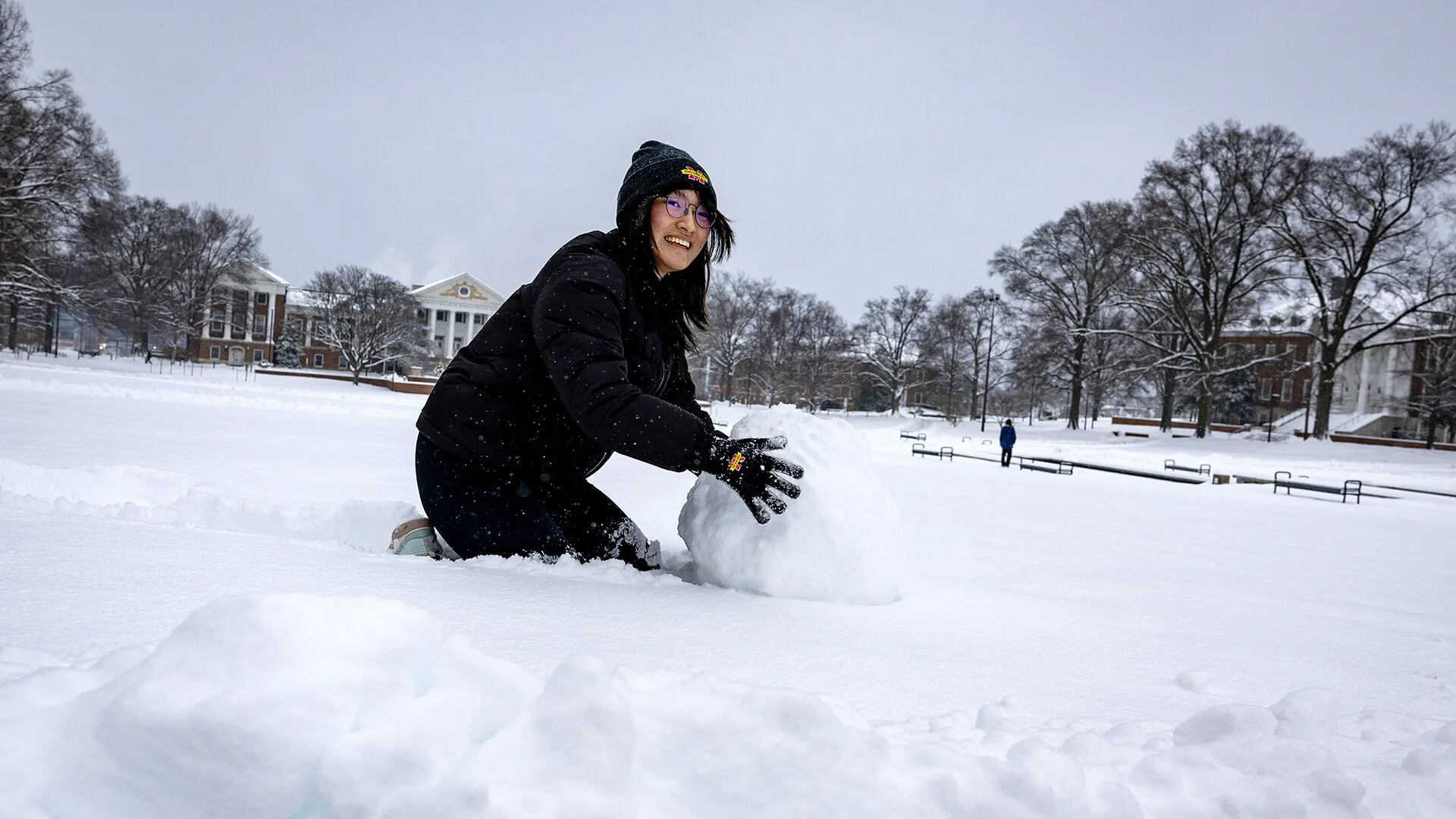 Student builds snowman on McKeldin Mall