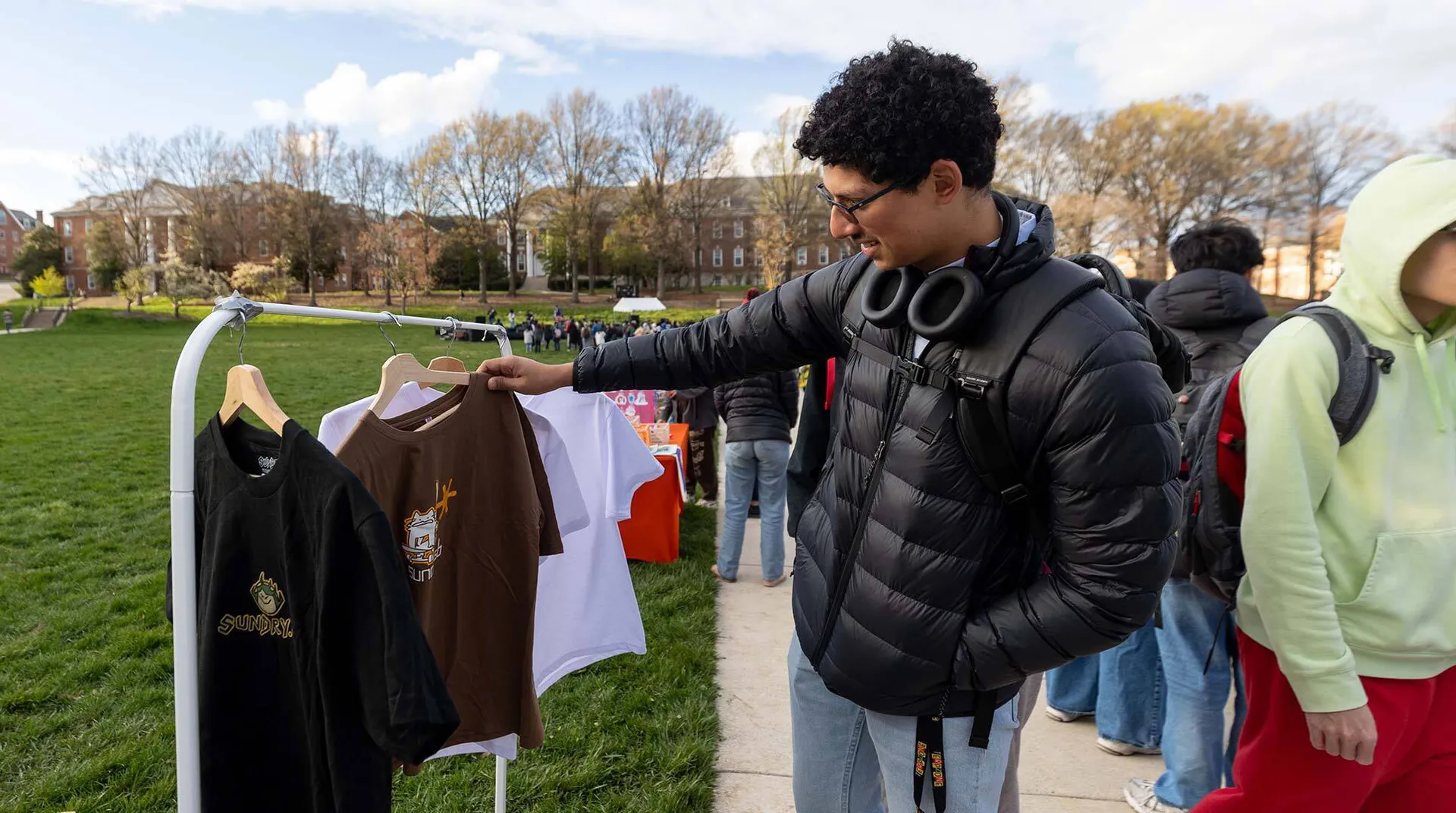 person looks at clothes on rack