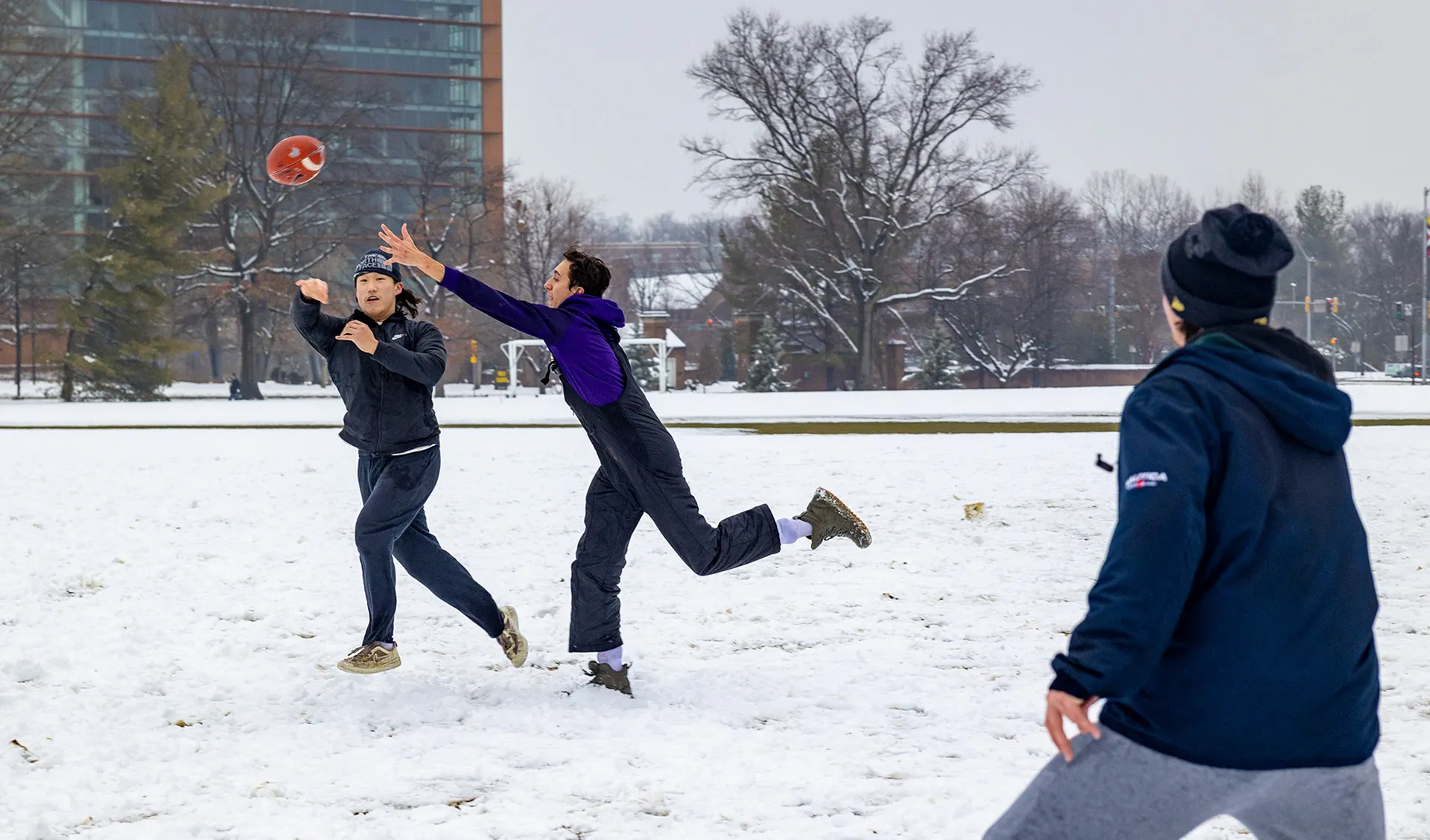 students play snow football