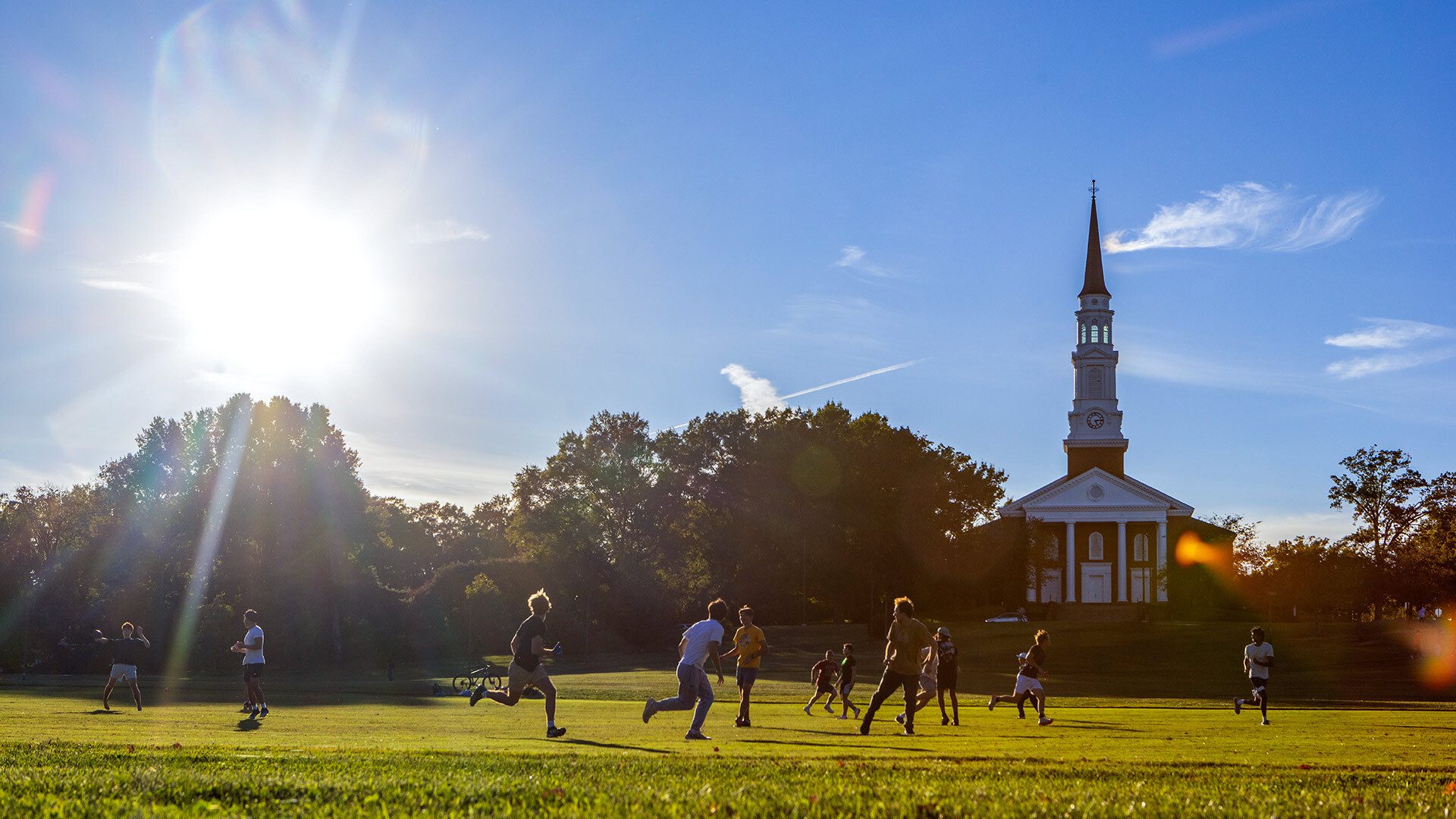 Students play football on the Chapel Fields in front of the Memorial Chapel