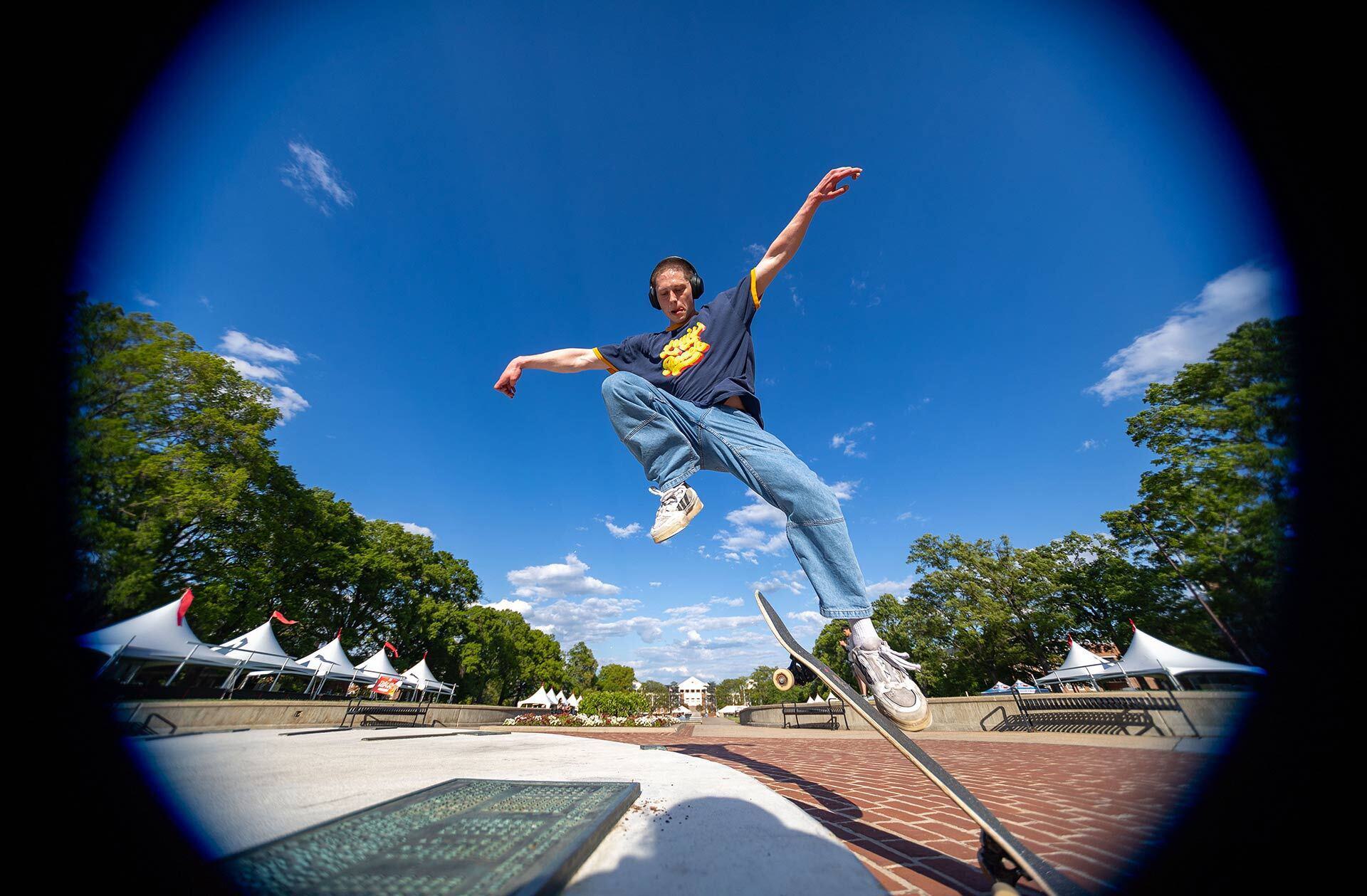 Student jumping off a skateboard