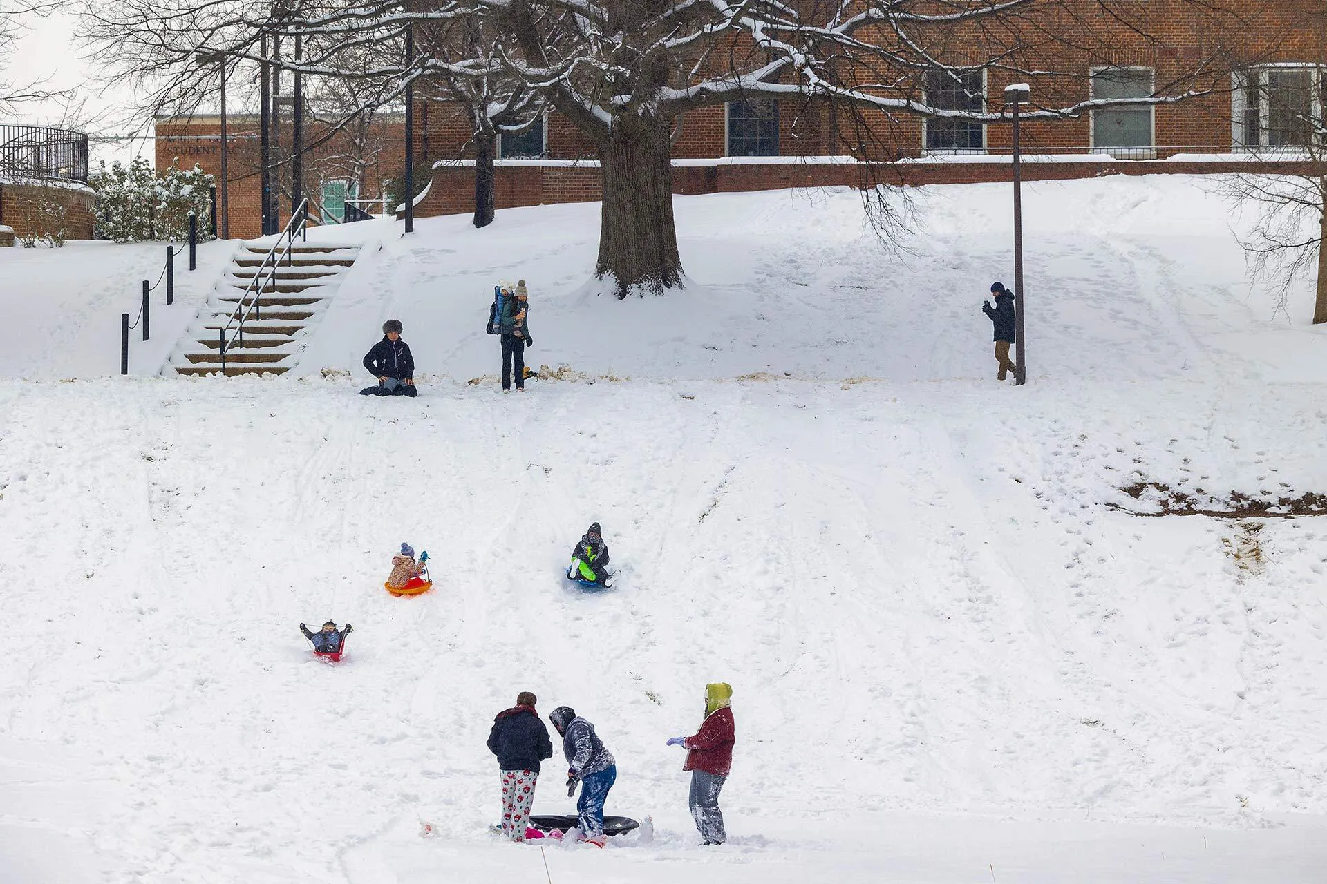 students sled on McKeldin Mall