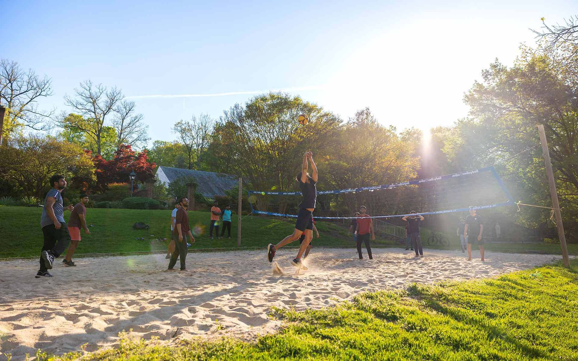 Students play sand volleyball