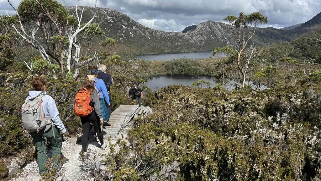 group walks down path in mountains