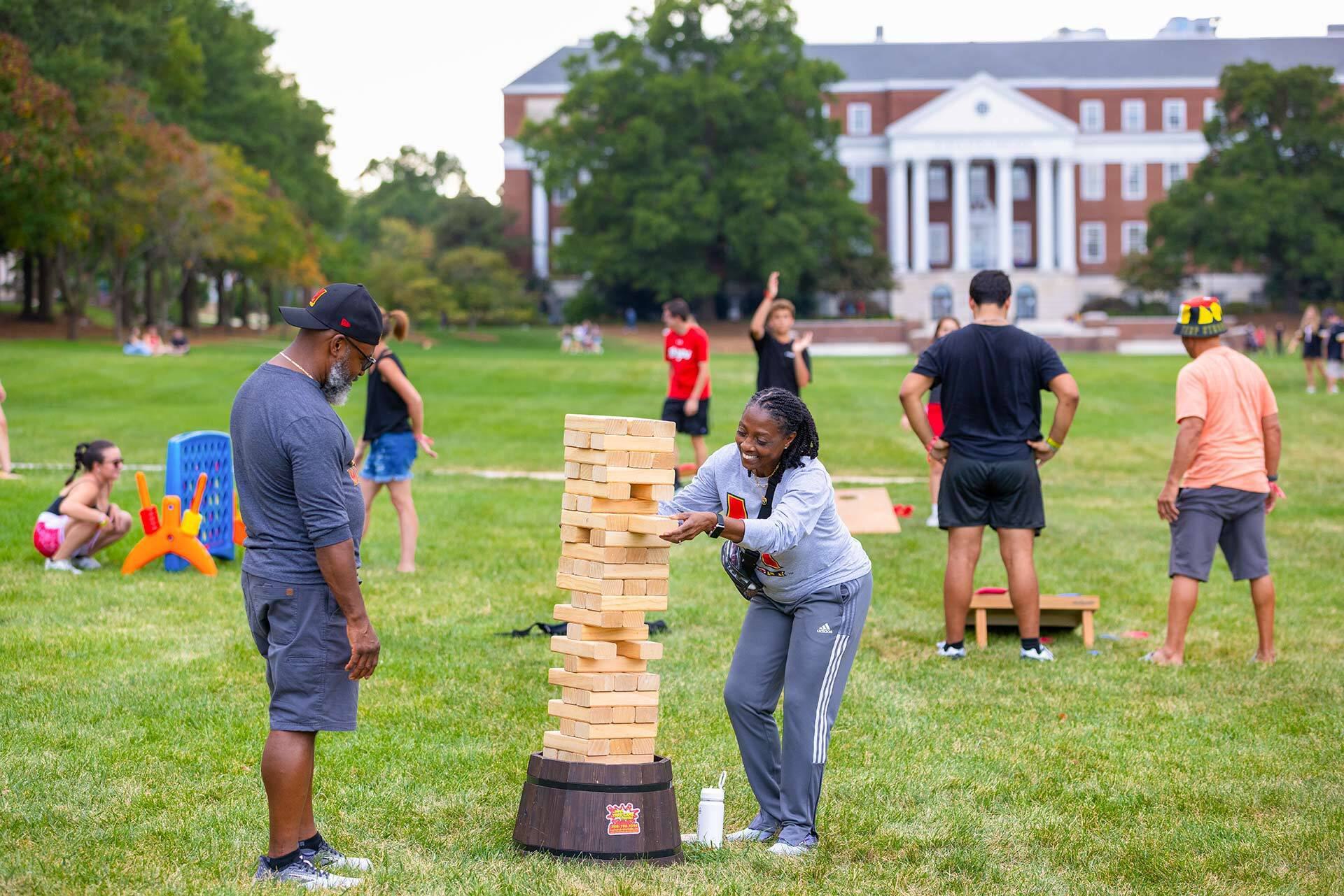 two people play giant jenga