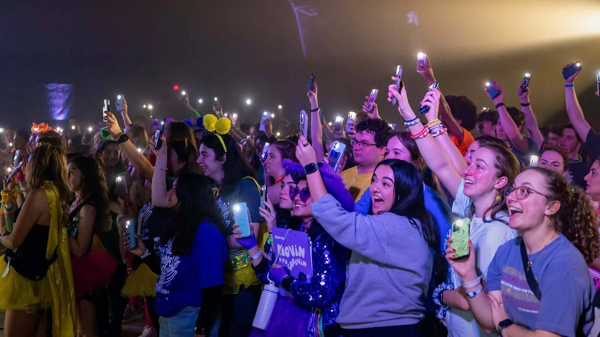 people cheer and hold up lights