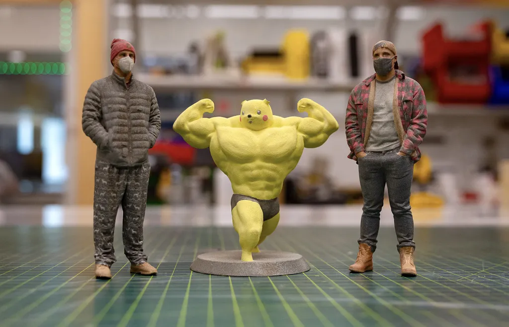 Two 3D-printed student figurines and a buff Pikachu
