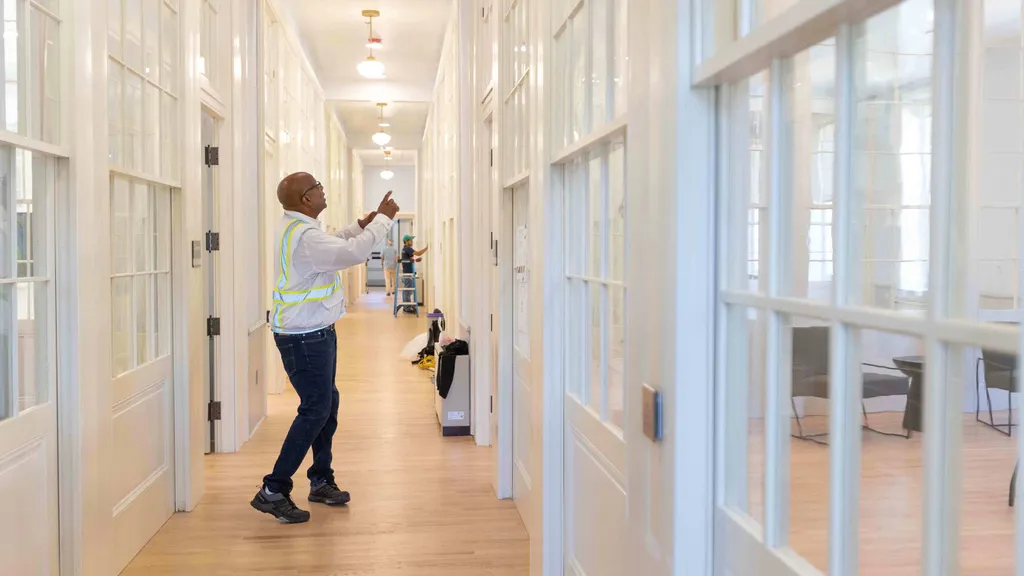 Man works in hallway of restored old school