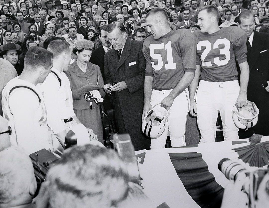 Queen and governor stand with football team captains