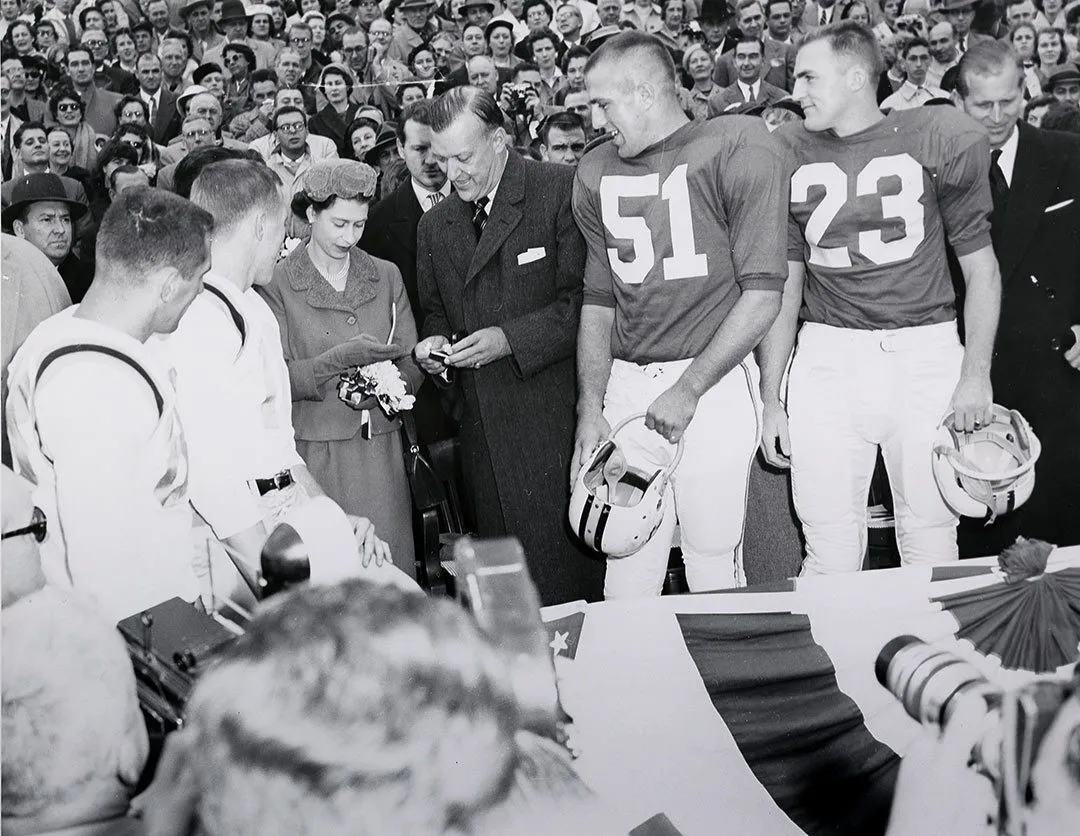 Queen and governor stand with football team captains