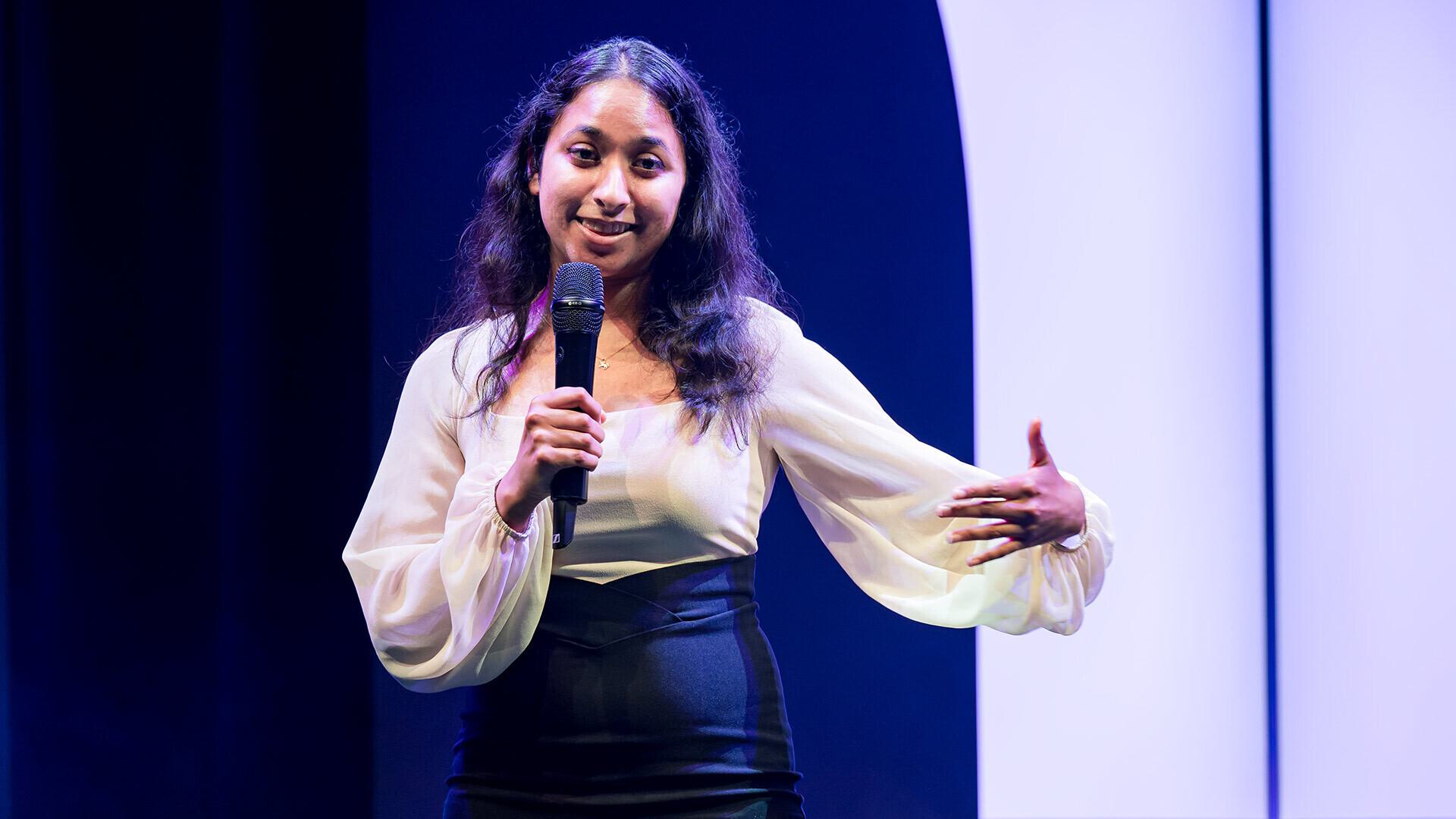 Akshaya Anand ’19, M.P.S. ’23 speaks on stage