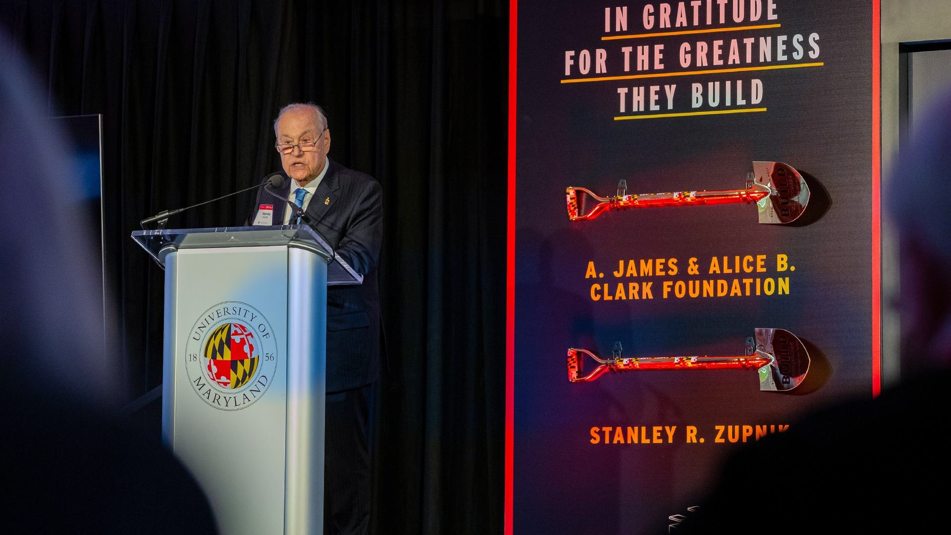 Zupnik speaks at podium