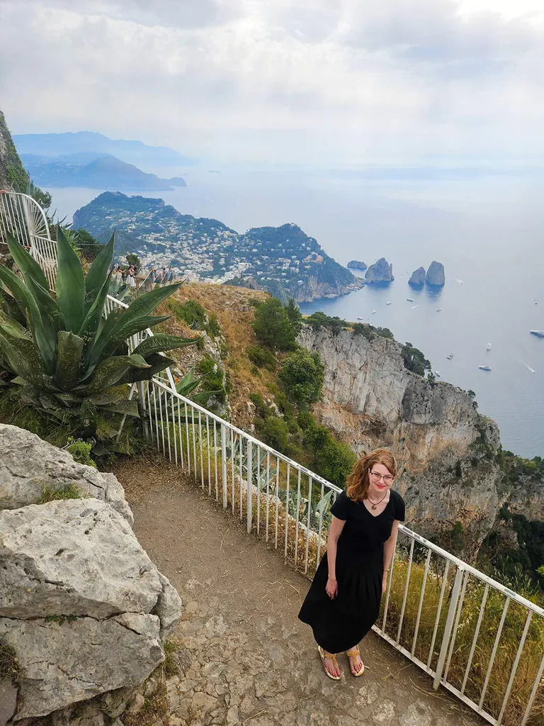 student poses near water in Italy