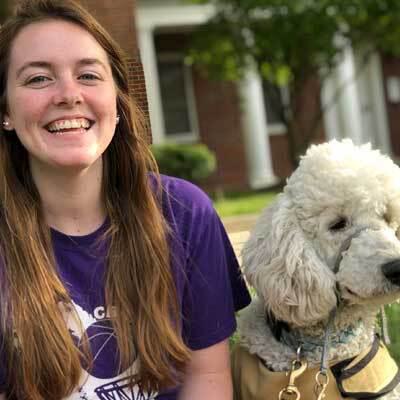 Cate Law headshot with poodle