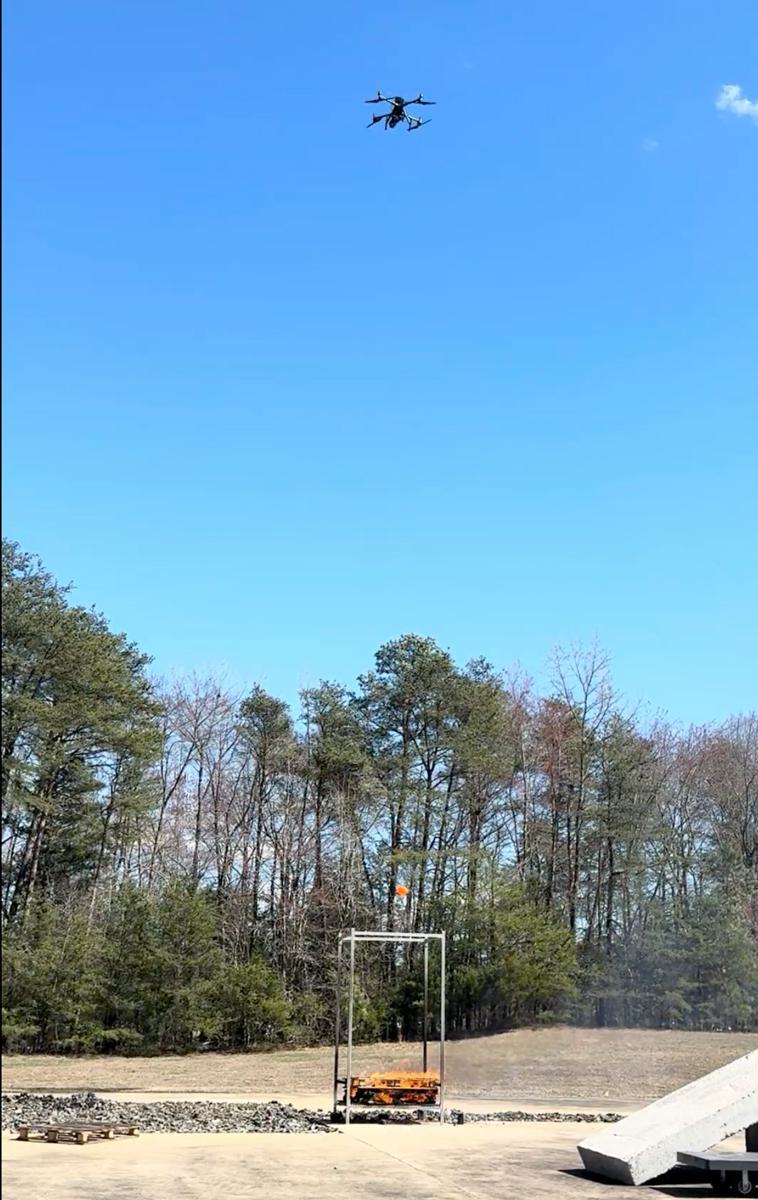 red water balloon falls from drone onto pallet fire