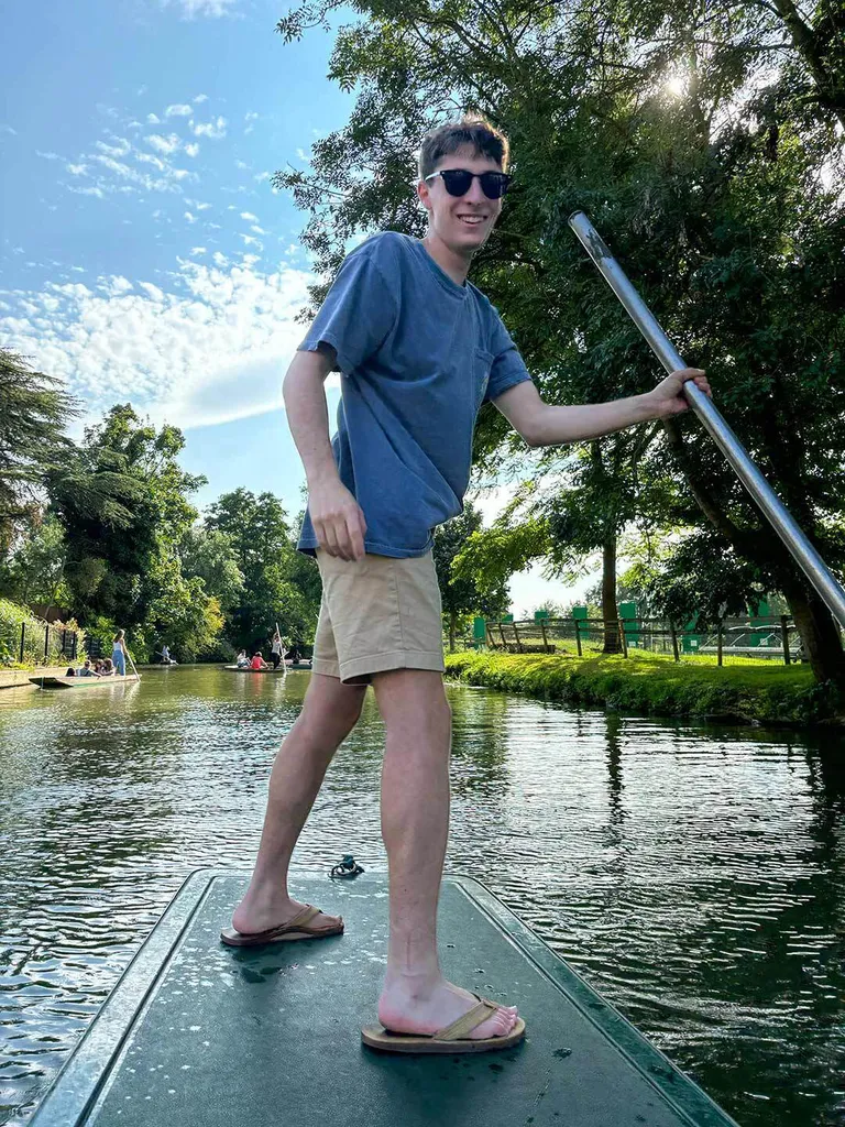 student pushes boat