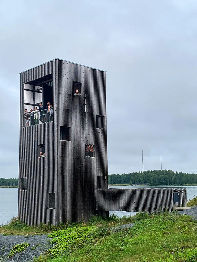 students peek out of unique structure