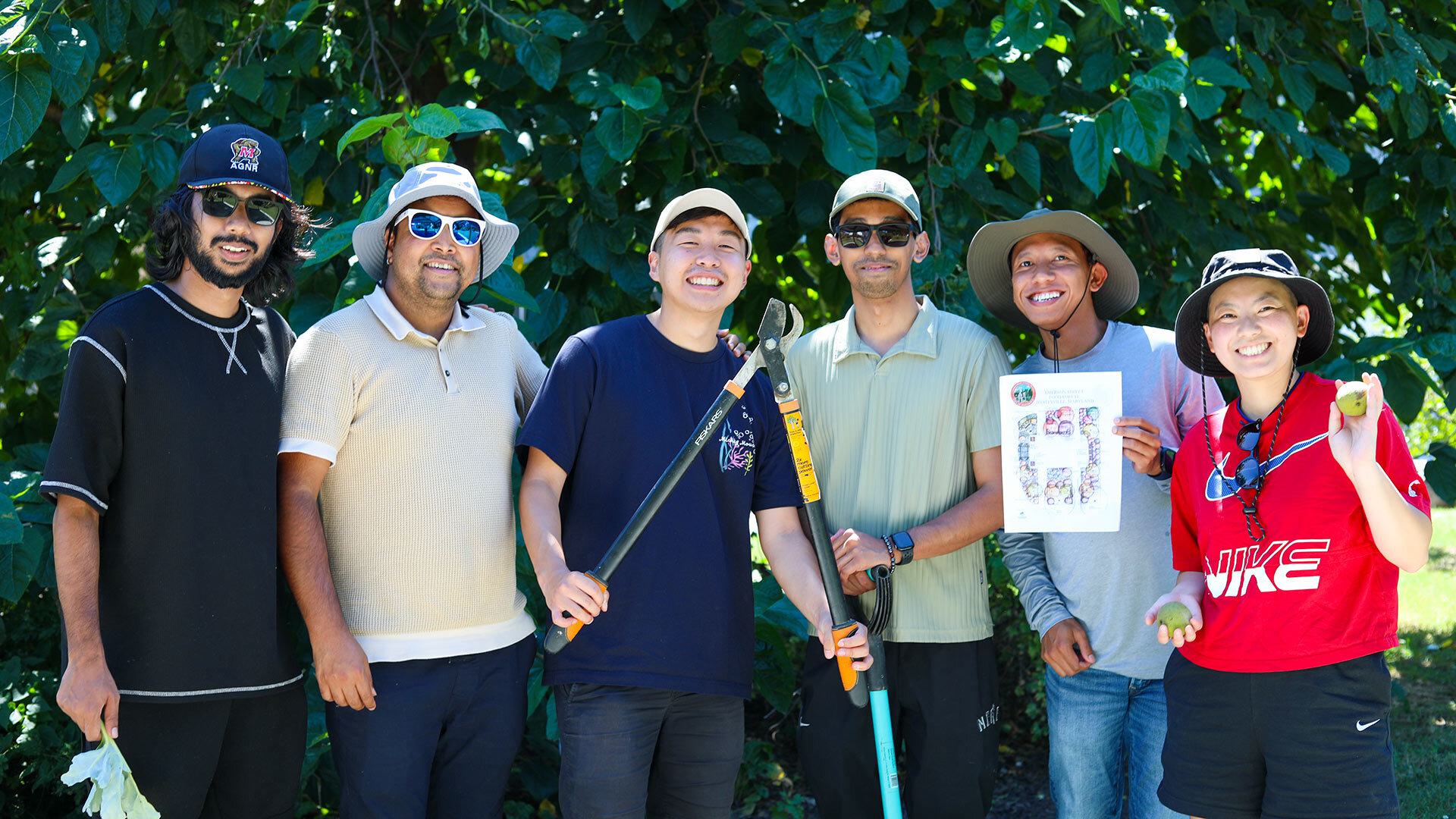 group of six poses under tree