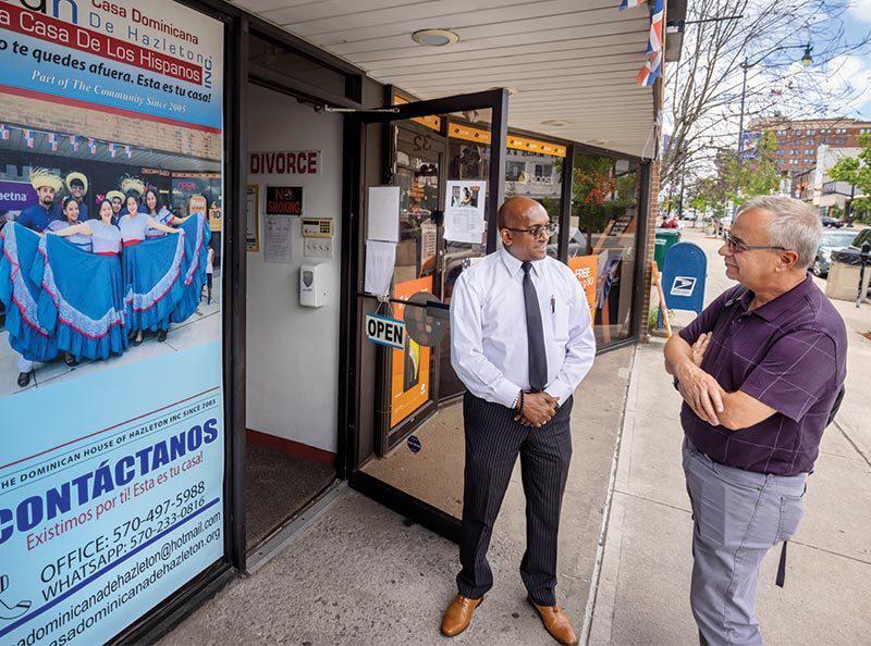 Anthropology Professor Paul Shackel, right, speaks with Victor Perez