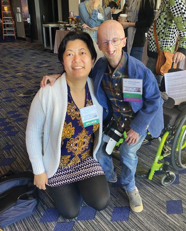 Cao poses with progeria patient Sammy Basso