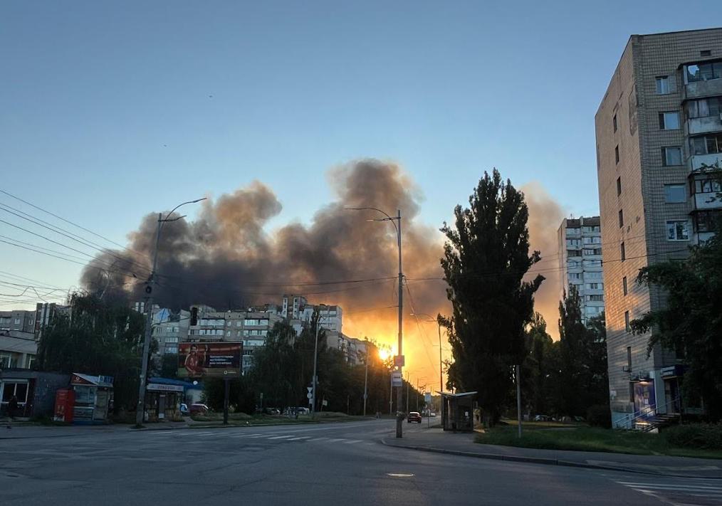 flames and smoke on city street after bombing in Kyiv