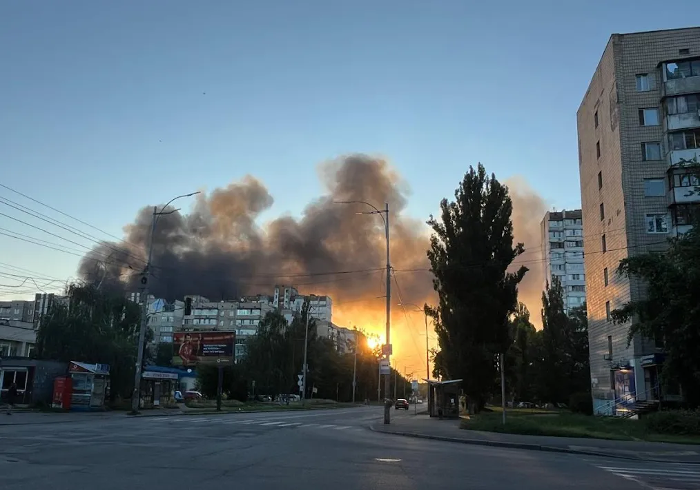 flames and smoke on city street after bombing in Kyiv
