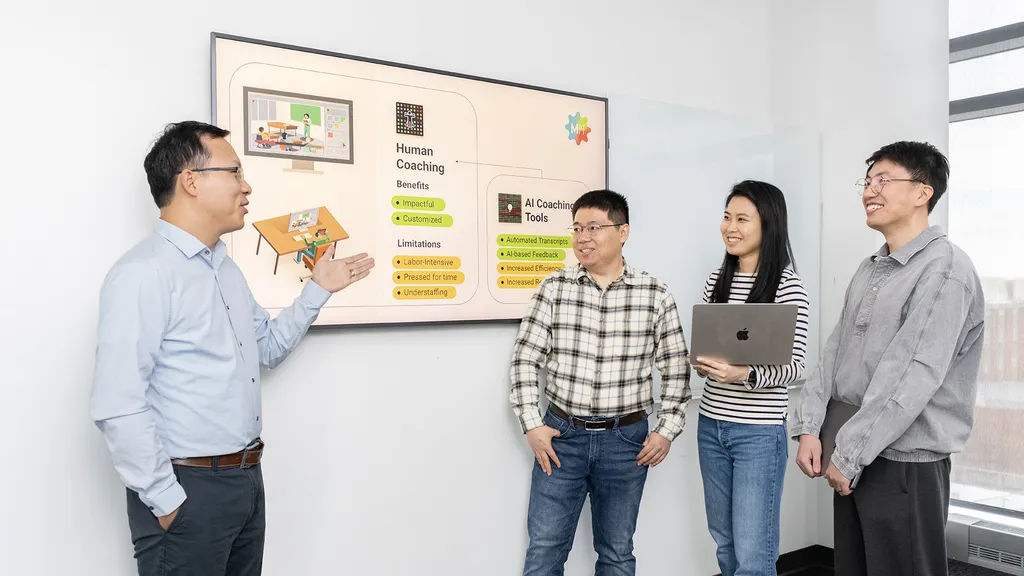 Researchers standing by a screen with information about human coaching