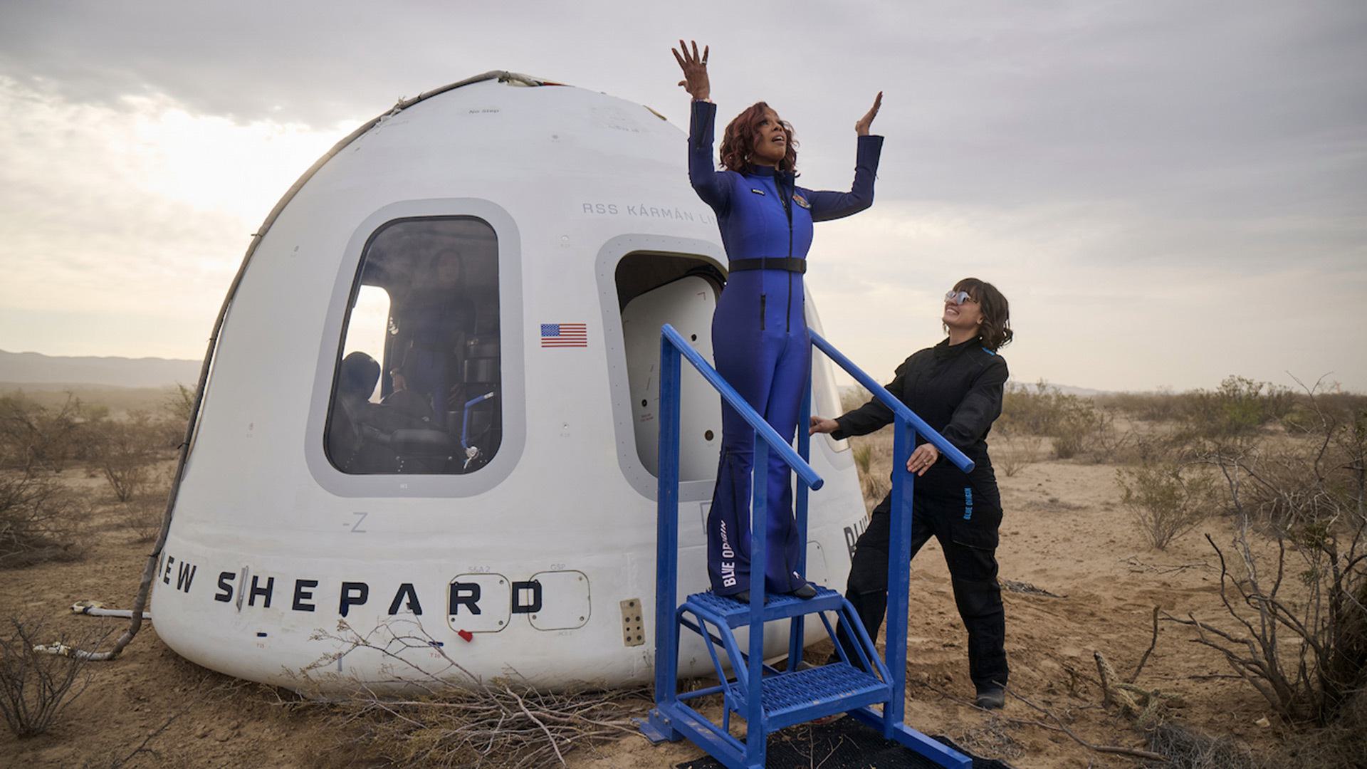Gayle King raises arms after exiting capsule back on Earth